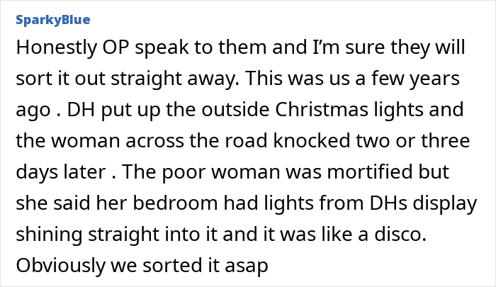 Neighbours installed actual sun decoration shining brightly on a house exterior during evening, illuminating the yard and porch area.