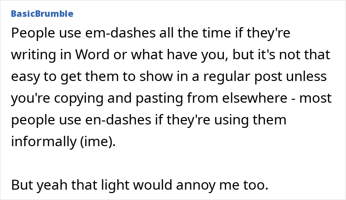 Modern house exterior with neighbours-installed actual sun solar panels shining under a clear blue sky on a bright day.
